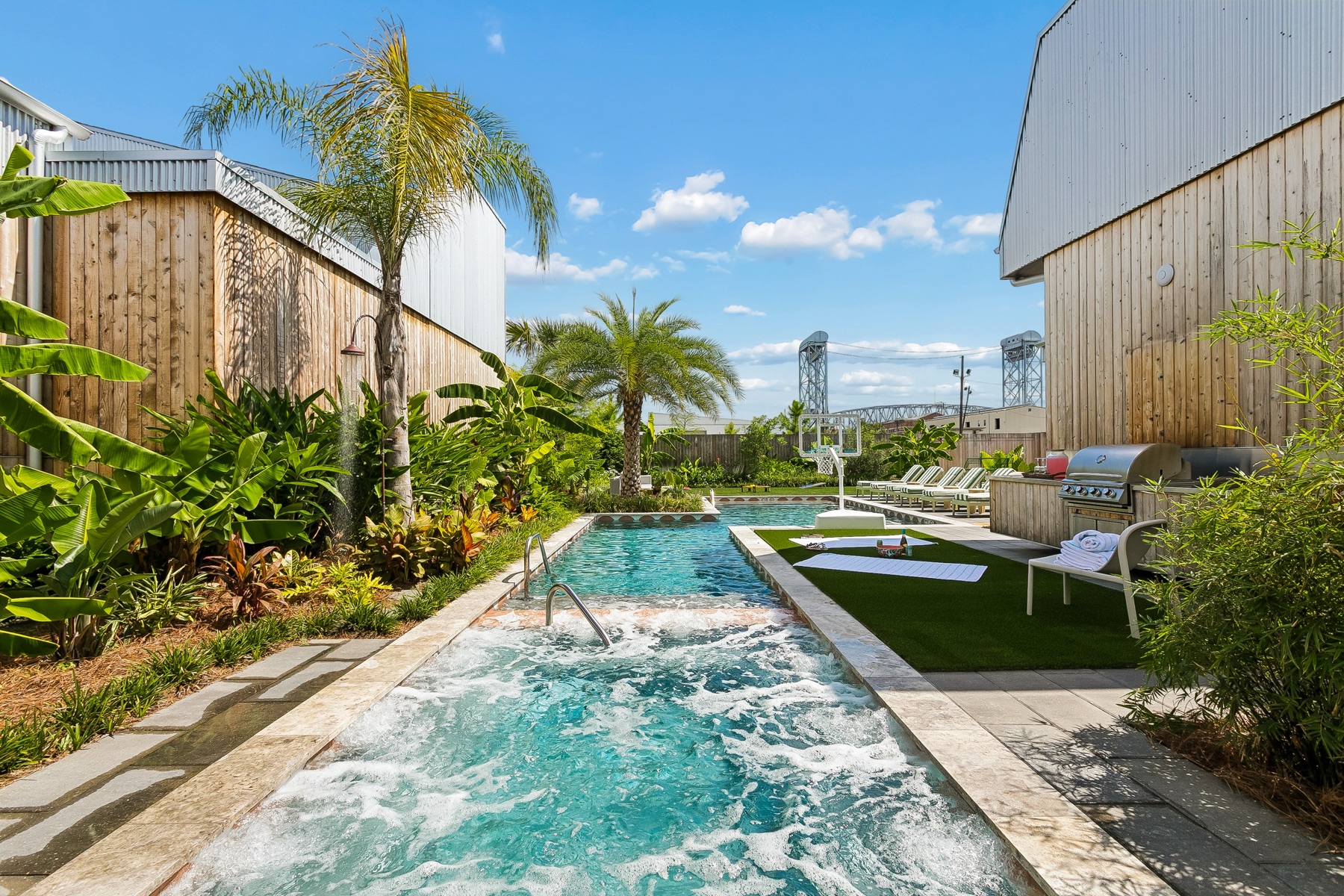 The hot tub bubbling with the pool beyond
