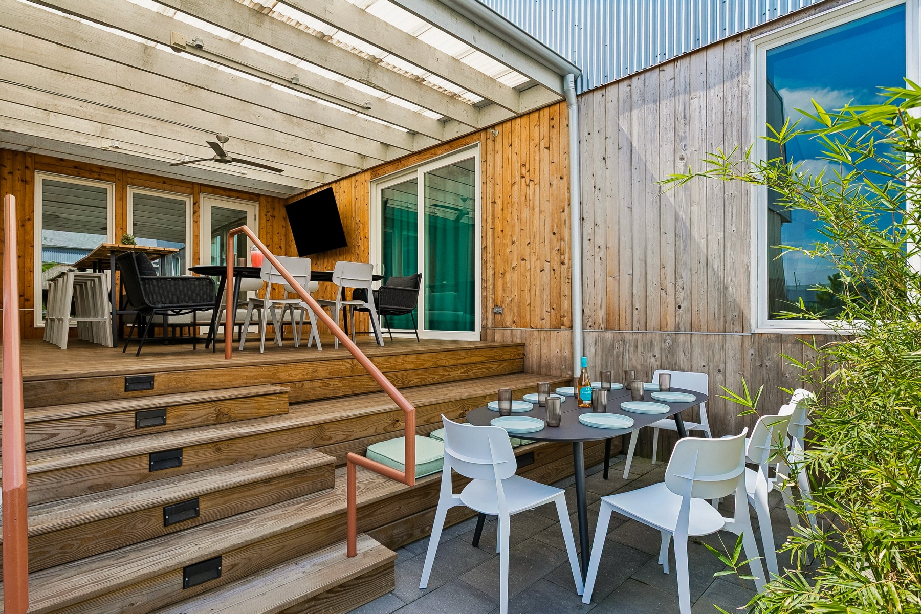 Dinner tables on the steps and under the pergola